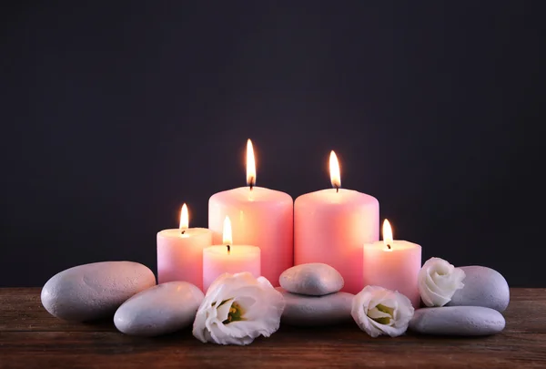 Spa stones with burning candles and flowers