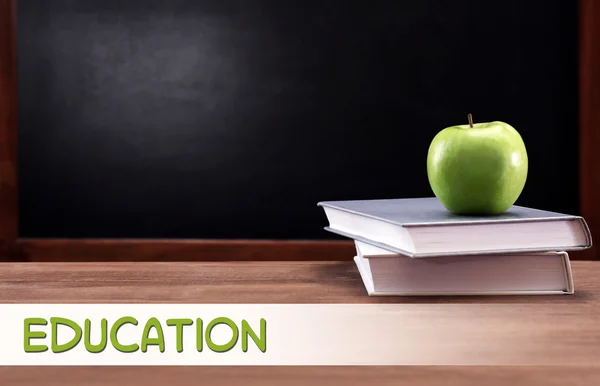 Apple and books on desk