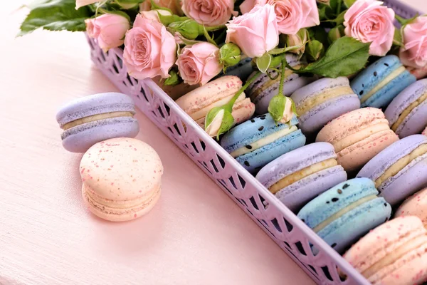 Tasty macaroons with beautiful roses