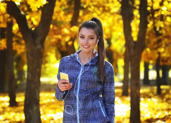 Young beautiful woman holding phone