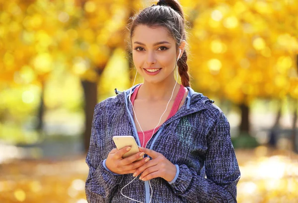 Young beautiful woman holding phone