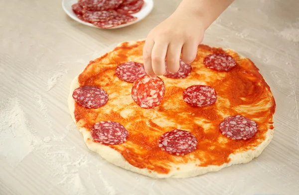 Kids with parents cooking pizza