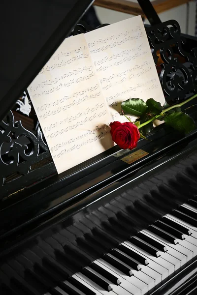 Musical notes and red rose