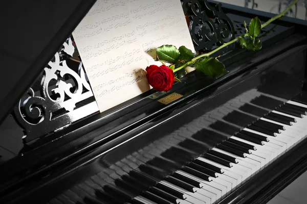 Musical notes and red rose