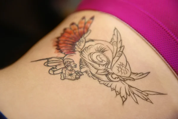 Tattoo owl on woman