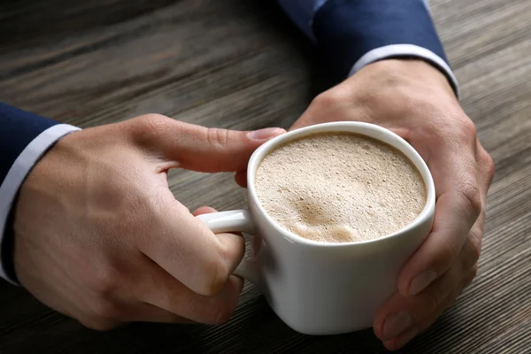 Man holding in hands cup of coffee