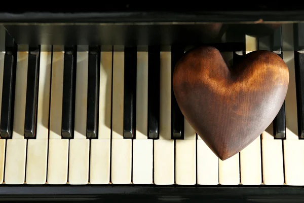 Brown heart on piano keys
