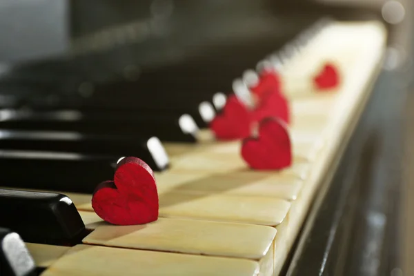Red hearts on piano keys