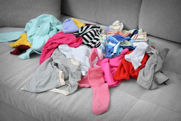 Chaos of clothes on couch