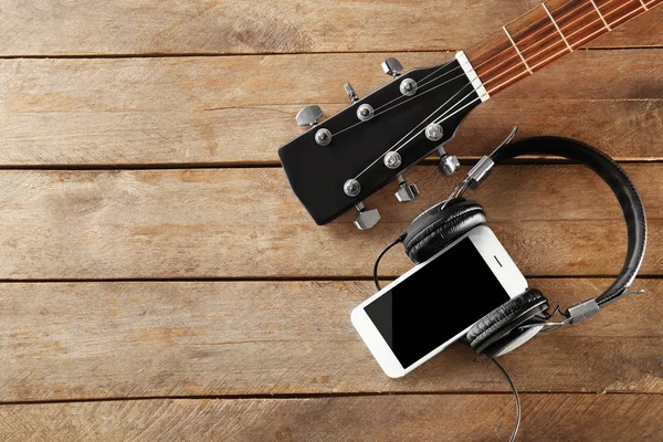 Smartphone with headphones and Guitar
