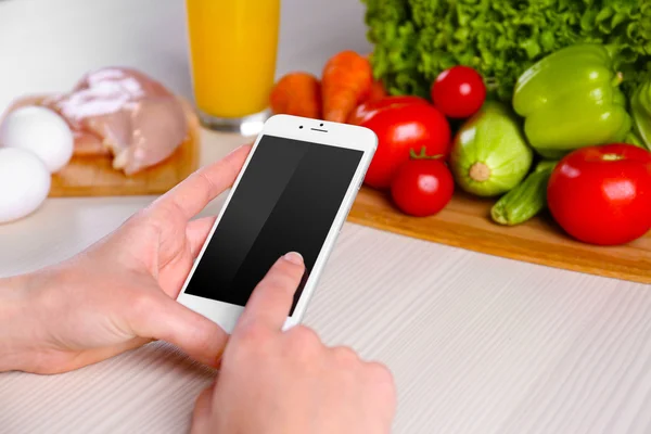 Woman reading recipe from smartphone