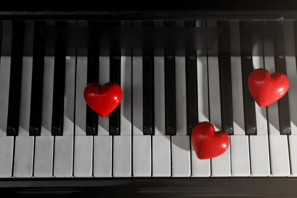 Red hearts on piano keys, close up