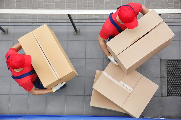 Male workers with heavy boxes