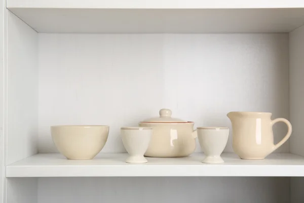 Tableware on shelf in the kitchen