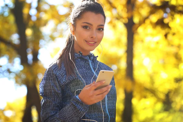 Young beautiful woman holding phone