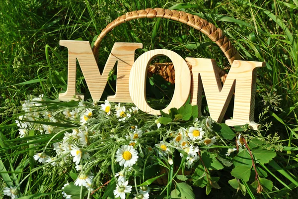 Word MOM made of wooden letters