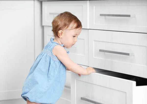 Child playing with cupboard