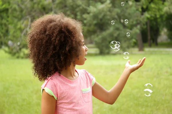 Girl catching soap bubbles