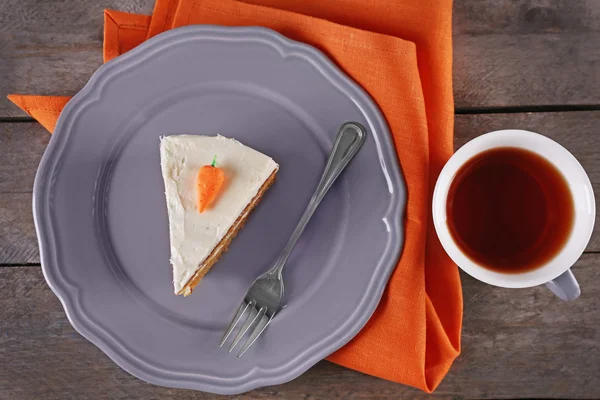 Piece of carrot cake with a cup of tea