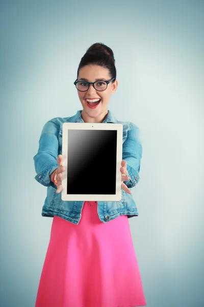 Cute young woman holding tablet