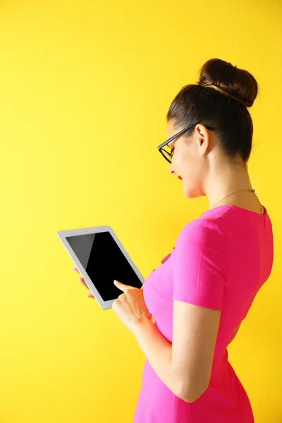 Cute young woman holding tablet