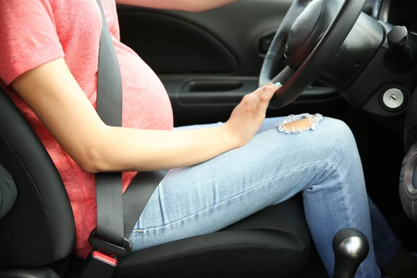 Pregnant woman driving car