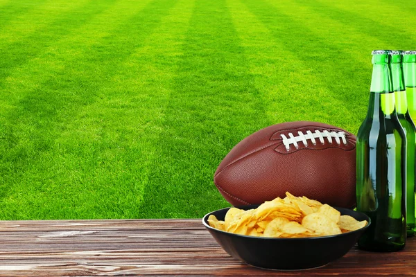 Snacks on football field background