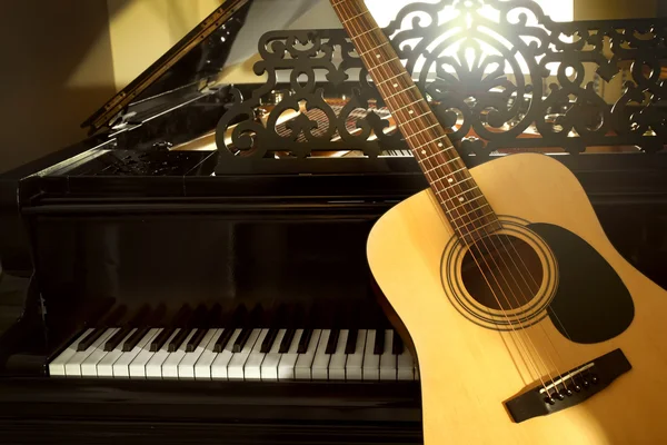 Guitar with piano, close up