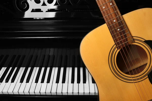 Guitar with piano, close up