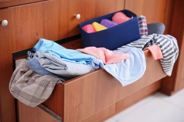 Pile of clothes in wooden drawer