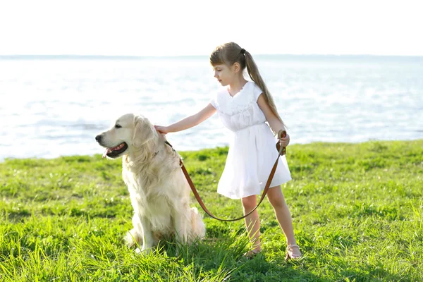 Little girl and big kind dog