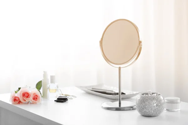 Round mirror on table