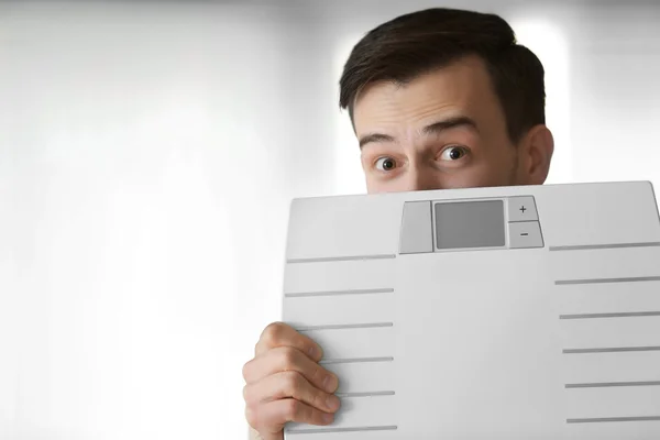 Man holding weight scale
