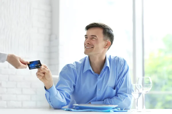 Businessman paying restaurant bill