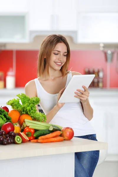 Woman with tablet and healthy food