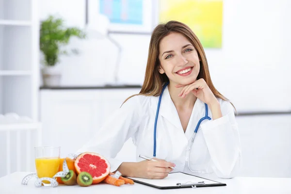 Female nutritionist with fruits