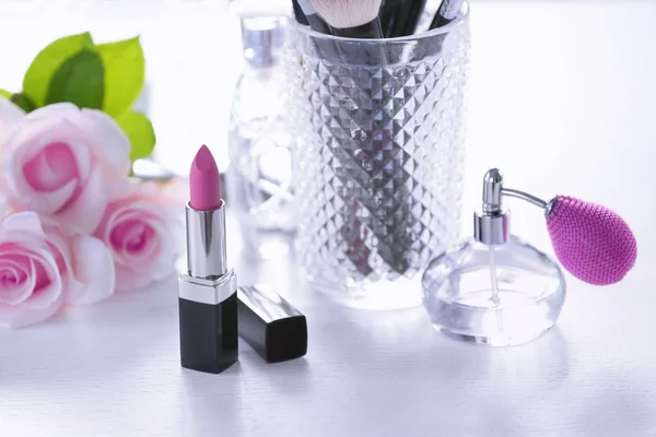 Opened lipstick on white dressing table