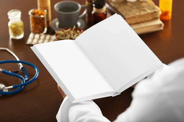 Male doctor with medical recipe book