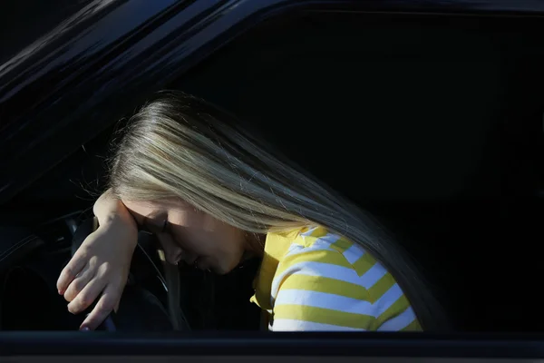 Woman falling asleep in car