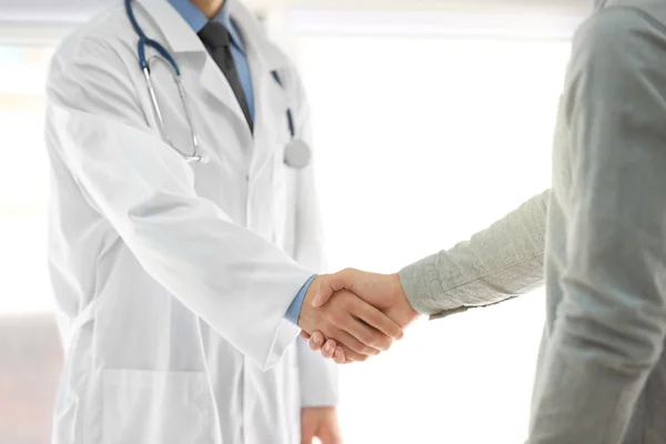 Doctor handshaking with patient