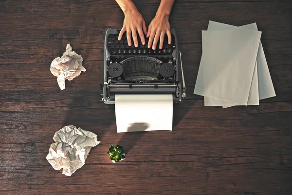 Hands working with retro typewriter