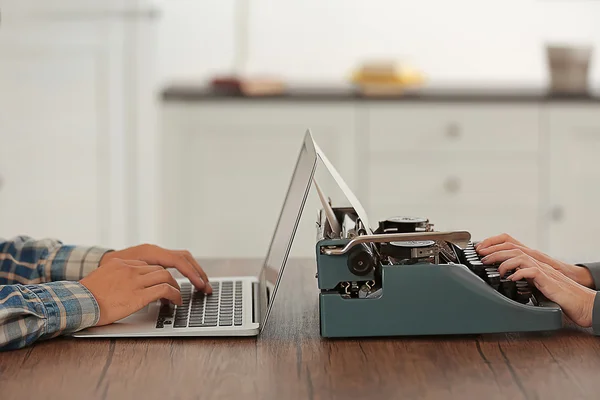 Old typewriter and laptop