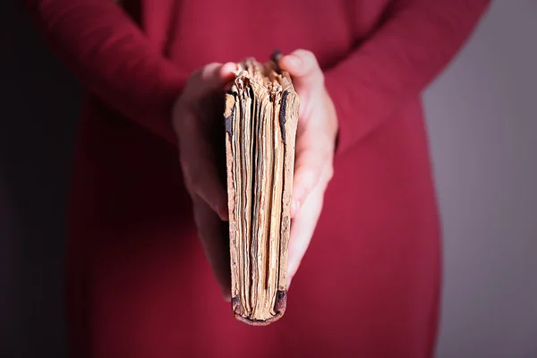 Woman holding old book