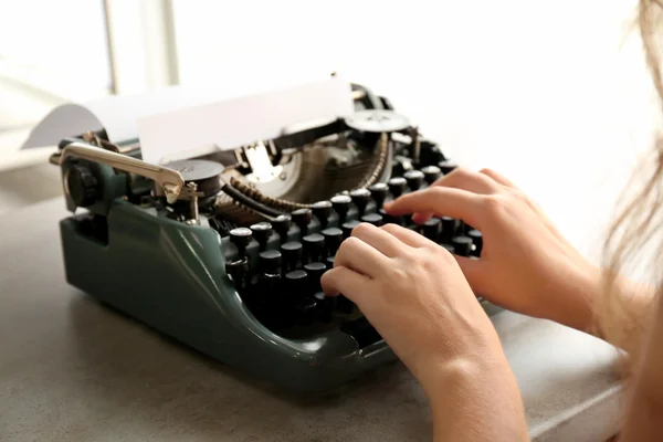Woman typing on the typewriter