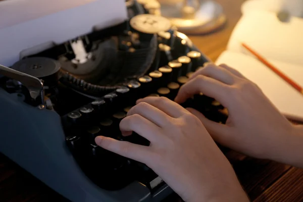 Woman typing on the typewriter