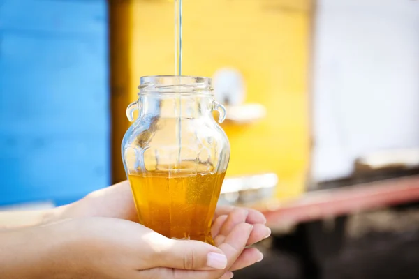 Pouring honey into bottle