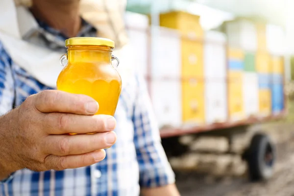 Man holding bottle of honey