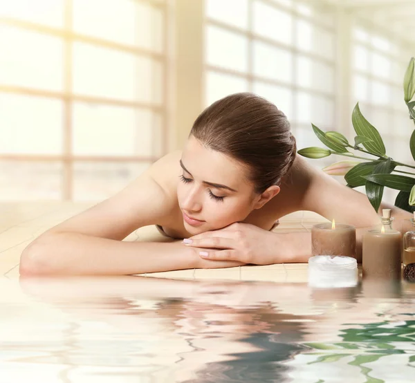 Beautiful woman lying on massage table.