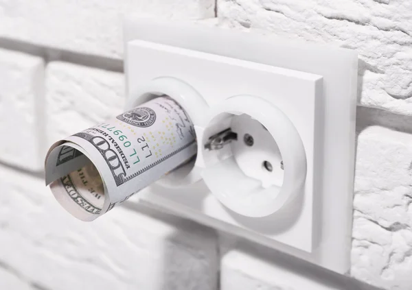 Dollars in socket on white wall
