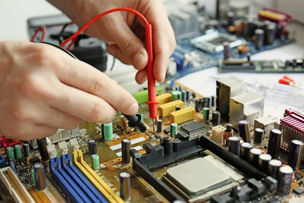 Man repairing motherboard